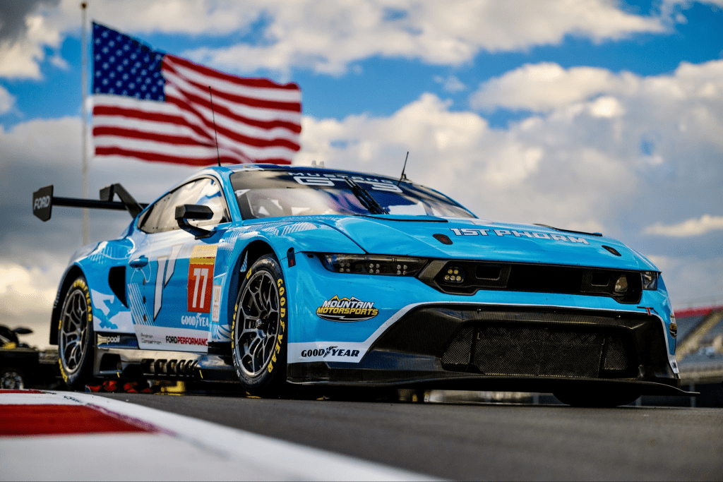 The #77 Mustang looking extremely American in Austin. Muscle car, flag, pretty much all they're missing is some guns and a bald eagle. Photo: Proton Competition