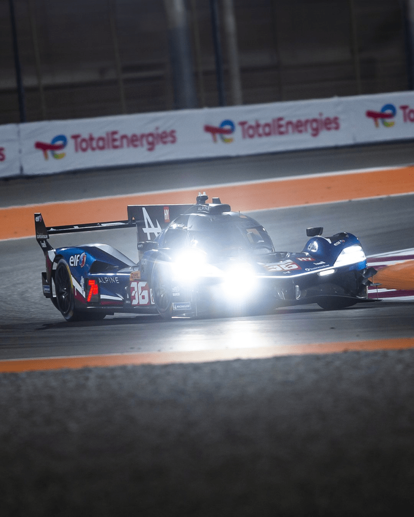 Alpine's #36 A424 runs through the night with headlights blazing during testing at Qatar.